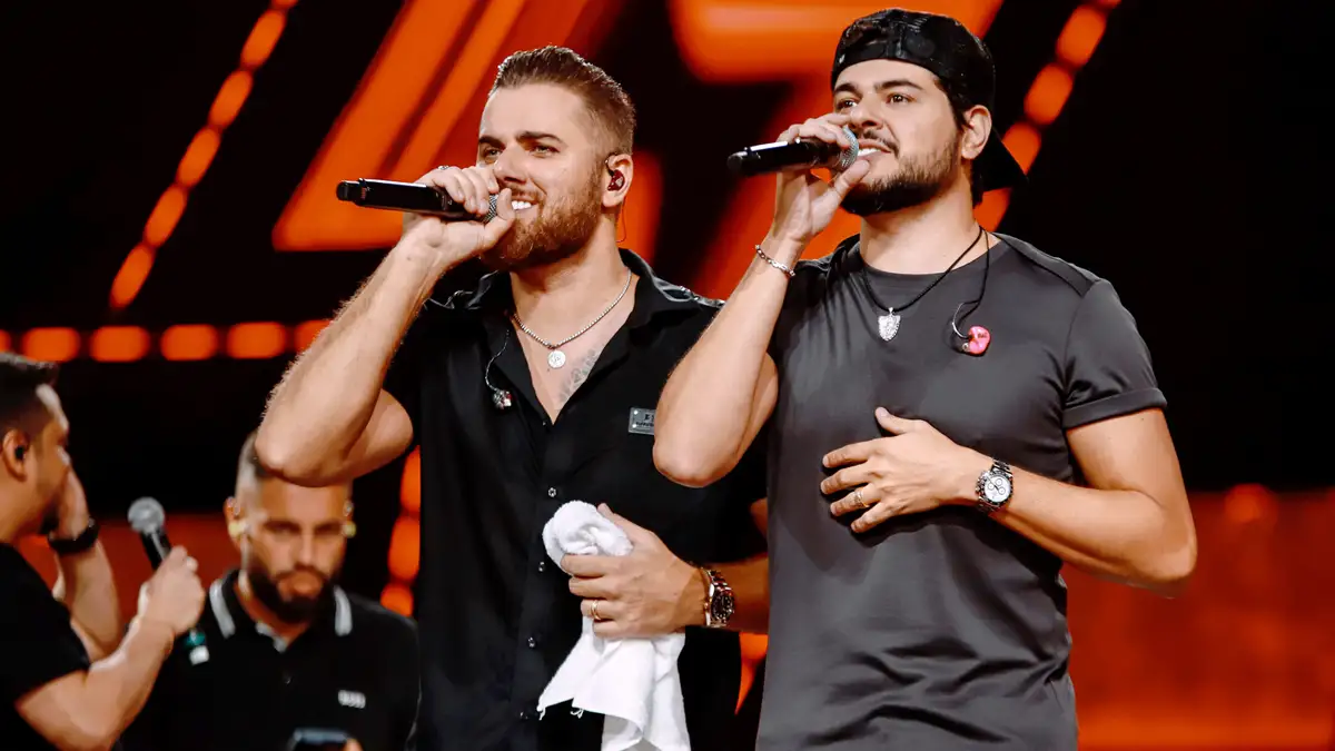 Zé Neto e Cristiano interrompem show em Portugal após flagrante de agressão contra mulher Dupla sertaneja denuncia agressor no palco e recebe aplausos do público durante apresentação em Porto (Foto: Reprodução Instagram)